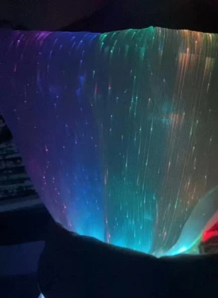 Illuminated texture at the garment surface.