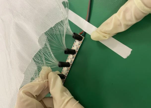 Assembling the fiber-optic elements.